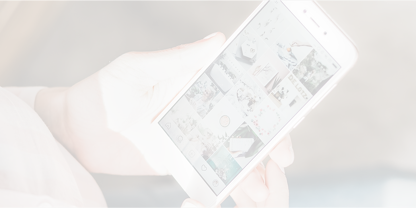 Person holding smartphone viewing social media app.