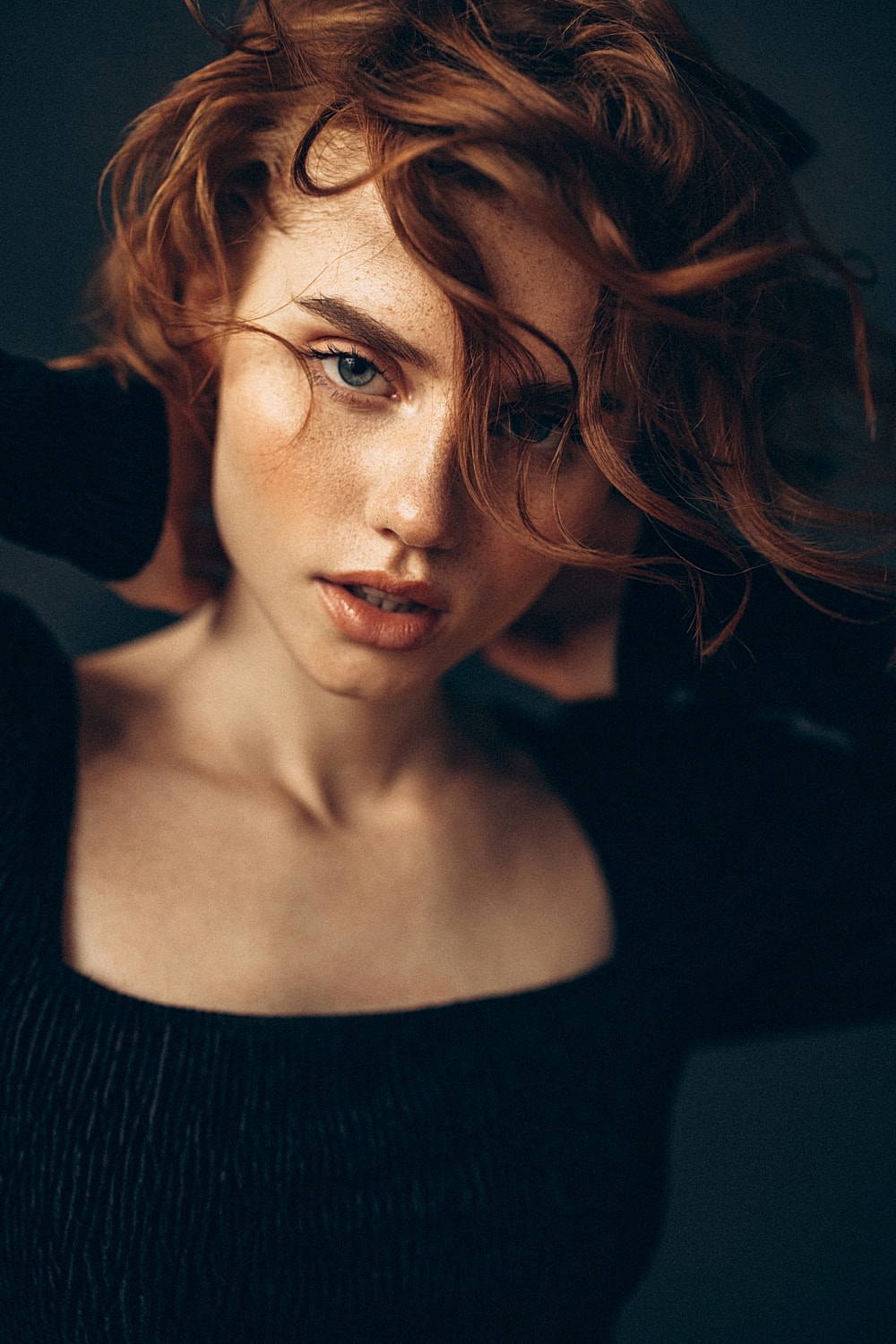 Portrait of a woman with flowing red hair.