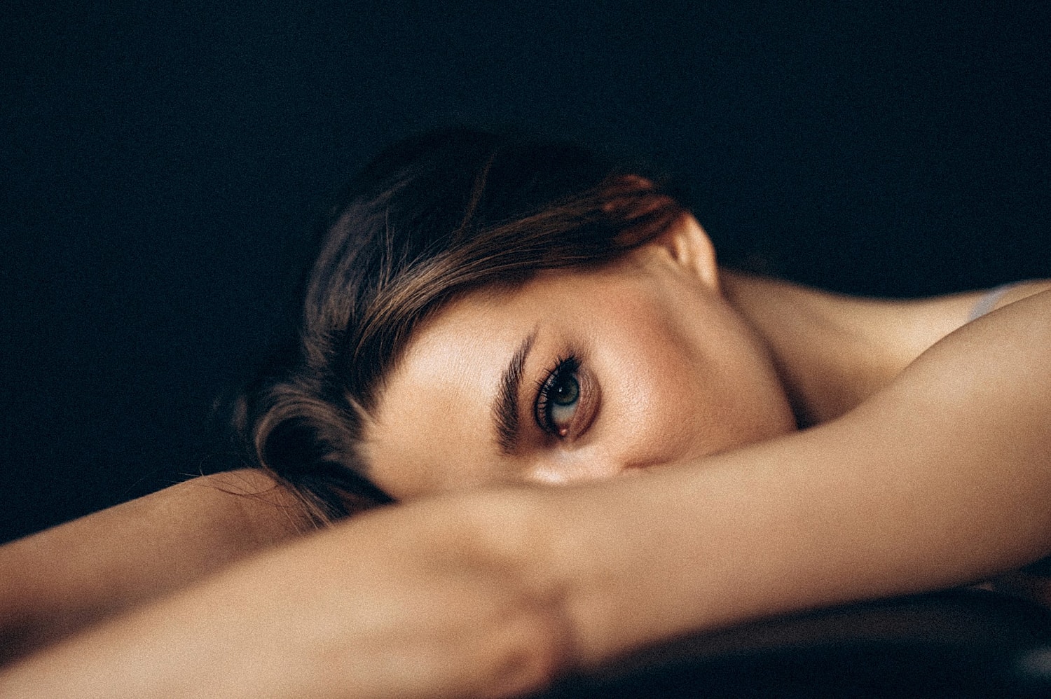 Close-up of a woman's face and arm.