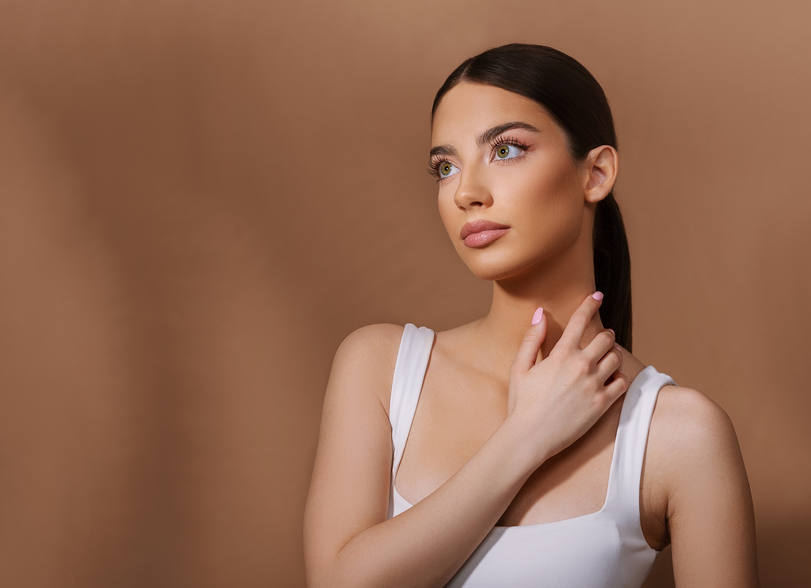 Woman in white top with elegant pose.